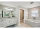 Bathroom with soaking tub, walk-in shower, and separate toilet area at 339 55Th Ave, St Pete Beach, FL 33706