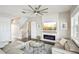 Bright living room featuring a fireplace, comfortable seating, and large windows at 339 55Th Ave, St Pete Beach, FL 33706