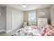 Bedroom with butterfly bedding, a white dresser, and double doors to a closet at 339 55Th Ave, St Pete Beach, FL 33706