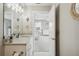 Bathroom with granite countertop, white cabinets and a view into a bedroom at 339 55Th Ave, St Pete Beach, FL 33706