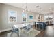 Bright dining room features a light wood table with blue and white chairs, adjacent to a kitchen at 339 55Th Ave, St Pete Beach, FL 33706