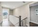 Upper level hallway with a modern railing and access to bedrooms at 339 55Th Ave, St Pete Beach, FL 33706