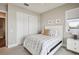 Bright bedroom with white bed frame and blue striped bedding, featuring a white closet at 339 55Th Ave, St Pete Beach, FL 33706