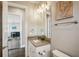 Bathroom with granite countertop, white cabinets, and a view into another room at 339 55Th Ave, St Pete Beach, FL 33706