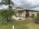 Tan house with palm trees and well-maintained landscaping at 6812 Aramon Ct, Wesley Chapel, FL 33545