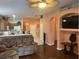 Open living room with hardwood floors and access to kitchen at 6812 Aramon Ct, Wesley Chapel, FL 33545
