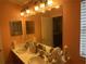 Bathroom with double vanity and large mirror at 6812 Aramon Ct, Wesley Chapel, FL 33545