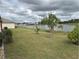 Spacious backyard with lake view and lush landscaping at 6812 Aramon Ct, Wesley Chapel, FL 33545