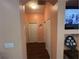 Hallway with light peach walls and wood flooring at 6812 Aramon Ct, Wesley Chapel, FL 33545