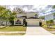 Two-story house with a two-car garage and lush lawn at 11205 Sailbrooke Dr, Riverview, FL 33579