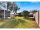 Landscaped backyard with grassy area and privacy fence at 11205 Sailbrooke Dr, Riverview, FL 33579