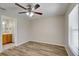 Bedroom with ceiling fan, window with blinds, and wood-look flooring at 3776 Junction St, North Port, FL 34288