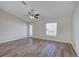 Bright living room featuring wood-look floors and ceiling fan at 3776 Junction St, North Port, FL 34288