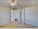 Bedroom with ceiling fan, access to bathroom and closet at 3776 Junction St, North Port, FL 34288