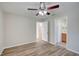 Bedroom with ceiling fan, wood-look flooring and en-suite bathroom at 3776 Junction St, North Port, FL 34288