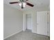 Bright bedroom with ceiling fan, tile flooring, and spacious closet at 3776 Junction St, North Port, FL 34288