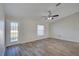 Living room with wood-look floors and sliding glass doors at 3776 Junction St, North Port, FL 34288