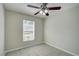 Bedroom with ceiling fan, window with blinds, and tile flooring at 3776 Junction St, North Port, FL 34288