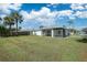 House exterior view, spacious backyard with screened patio at 3776 Junction St, North Port, FL 34288