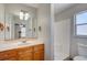 Bathroom with tub, vanity, and window at 3776 Junction St, North Port, FL 34288