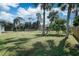 Large backyard with grassy area and palm trees at 3776 Junction St, North Port, FL 34288