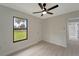 Spacious bedroom with ceiling fan, large window, and access to another room at 4501 Harrington St, Port Charlotte, FL 33948