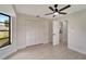 Bedroom with ceiling fan, window, and access to another room at 4501 Harrington St, Port Charlotte, FL 33948