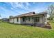 Ranch-style home with a screened-in patio and spacious backyard at 4501 Harrington St, Port Charlotte, FL 33948