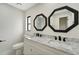 Modern bathroom with double vanity, marble countertops, and octagon mirrors at 4501 Harrington St, Port Charlotte, FL 33948