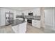 Modern kitchen with white cabinets, granite countertop and stainless steel appliances at 4501 Harrington St, Port Charlotte, FL 33948