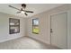 Bright bedroom featuring ceiling fan, new flooring, and an exterior door at 4501 Harrington St, Port Charlotte, FL 33948
