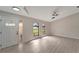 Spacious living room featuring large windows and wood-look floors at 4501 Harrington St, Port Charlotte, FL 33948