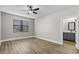 This bedroom features wood flooring, a ceiling fan, and a window for natural light at 5321 Crestline Ter, Port Charlotte, FL 33981