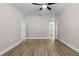 A spacious bedroom is complete with two entry doorways and beautiful wood-look flooring at 5321 Crestline Ter, Port Charlotte, FL 33981
