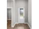 Bright entryway with wood-look flooring and a white front door with a decorative glass window at 5321 Crestline Ter, Port Charlotte, FL 33981