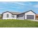 Charming single-story home features a gray facade, well-manicured lawn, and a gray brick driveway at 5321 Crestline Ter, Port Charlotte, FL 33981