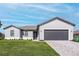 Charming single-story home features a gray facade, well-manicured lawn, and a gray brick driveway at 5321 Crestline Ter, Port Charlotte, FL 33981