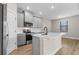 Modern kitchen with gray cabinets, quartz counters, stainless steel appliances, and an island at 5321 Crestline Ter, Port Charlotte, FL 33981