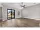Open living area with wood-look flooring, bright light, and sliding glass doors to the patio at 5321 Crestline Ter, Port Charlotte, FL 33981