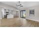 Open-concept living area featuring modern lighting, sliding glass doors, and view into the kitchen at 5321 Crestline Ter, Port Charlotte, FL 33981