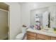 Bathroom boasts a shower, toilet and wood vanity with sink at 5512 Whitmore Dr, Tampa, FL 33634