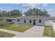 Newly renovated single-story home with gray exterior, driveway, and small front yard at 5512 Whitmore Dr, Tampa, FL 33634