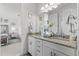 Bathroom featuring dual sinks, granite countertop, bright lighting, and neutral tones at 8414 Dunham Station Dr, Tampa, FL 33647