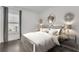 Cozy bedroom with a soft white bed, decorative accents, side tables, and natural light from the window at 8414 Dunham Station Dr, Tampa, FL 33647