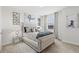 Luxurious bedroom showcasing a tufted headboard, decorative pillows, and stylish wall decor at 8414 Dunham Station Dr, Tampa, FL 33647