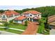 Stately home featuring a well-manicured lawn and driveway, with three-car garage at 8414 Dunham Station Dr, Tampa, FL 33647