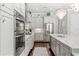 Spacious kitchen with stainless steel appliances, light gray cabinets, and a decorative light fixture at 8414 Dunham Station Dr, Tampa, FL 33647