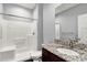 Clean bathroom with a walk-in shower, granite vanity, and toilet at 8448 Red Roe Dr, New Port Richey, FL 34653