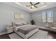 Bedroom with a queen-size bed, nightstands and ceiling fan at 8448 Red Roe Dr, New Port Richey, FL 34653