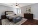 Spacious bedroom with a king-size bed, dresser, and wood floors at 8448 Red Roe Dr, New Port Richey, FL 34653